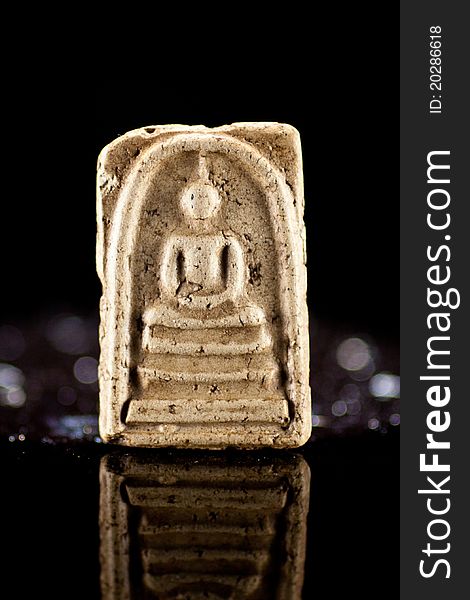 Small buddha reflect on black back ground.