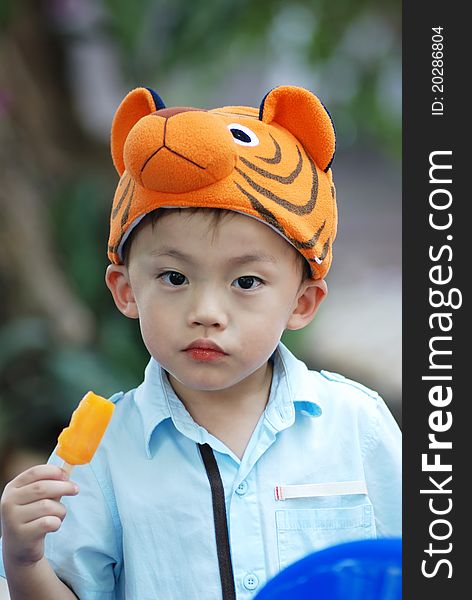 Asian young boy eating an icecream