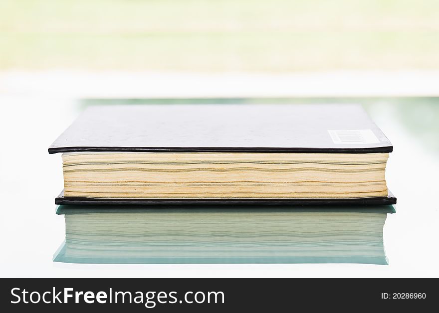 Blank book with black cover on background