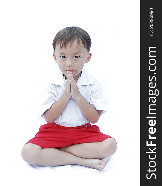 Cute young asian boy in uniform isolated on white background