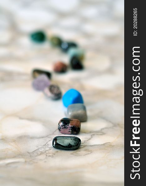 Small polished colorful stones in a row. Small polished colorful stones in a row