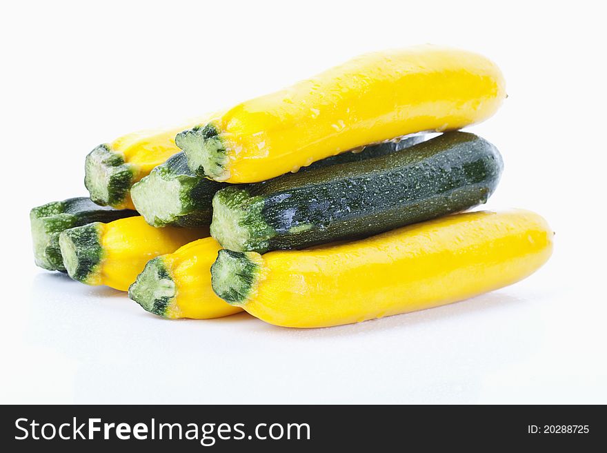 Green and yellow zucchinis on white background