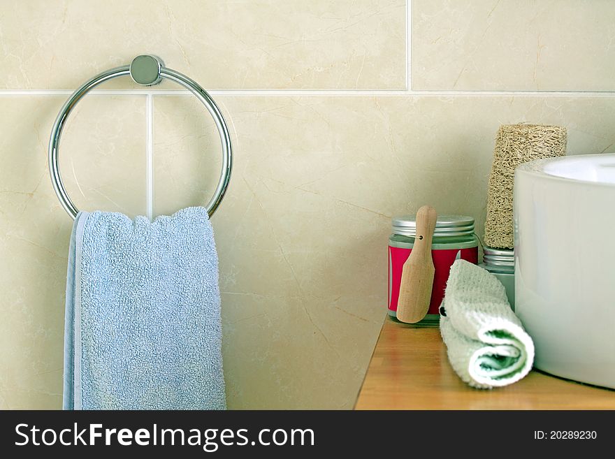 Towel hanging on a wall and bath salts next to the sink. Towel hanging on a wall and bath salts next to the sink