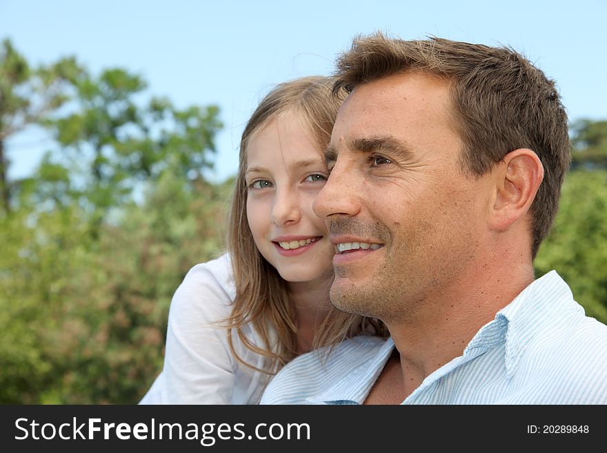 Father and daughter sitting in park. Father and daughter sitting in park