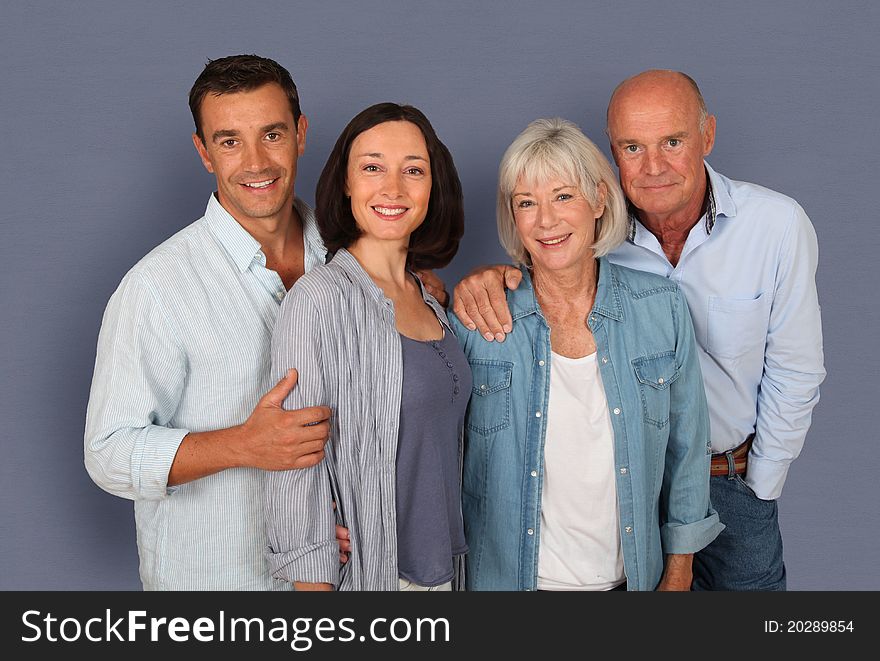 Family of four people standing on grey background. Family of four people standing on grey background