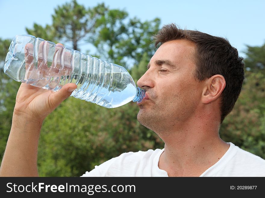 Adult man drinking water on a hot day. Adult man drinking water on a hot day