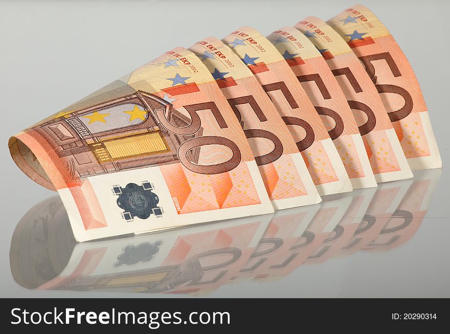 Euro banknotes isolated on grey with reflection