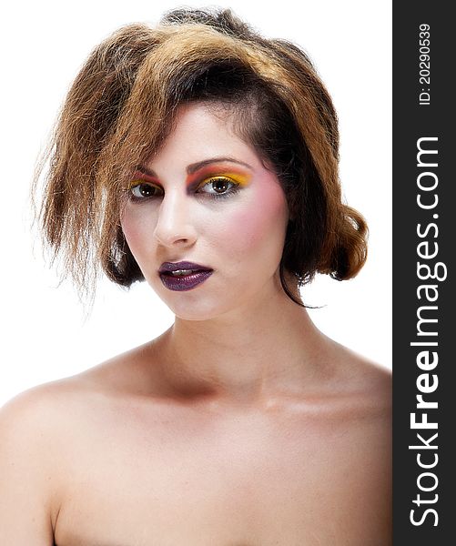 Beautiful young female against white with colourful make up