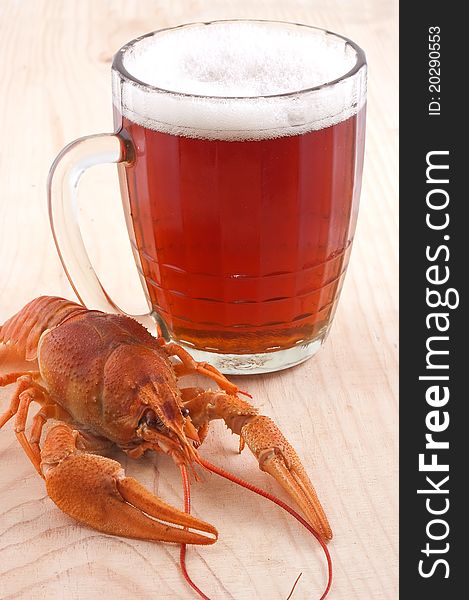 Beer mug and cancers isolated on a wooden board on a white background