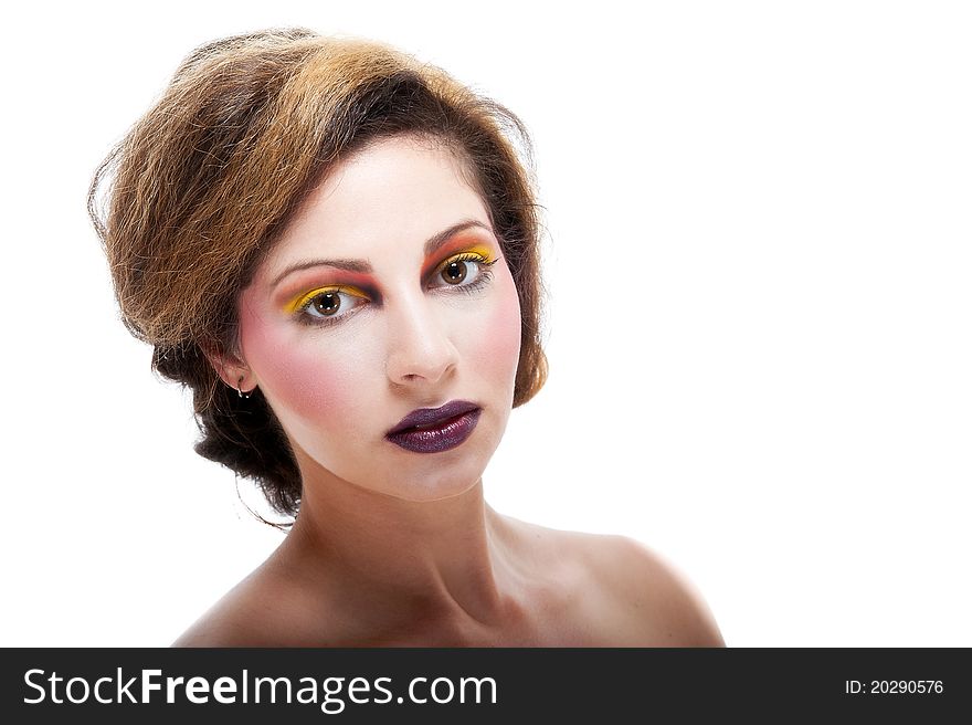 Beautiful young female against white with colourful make up