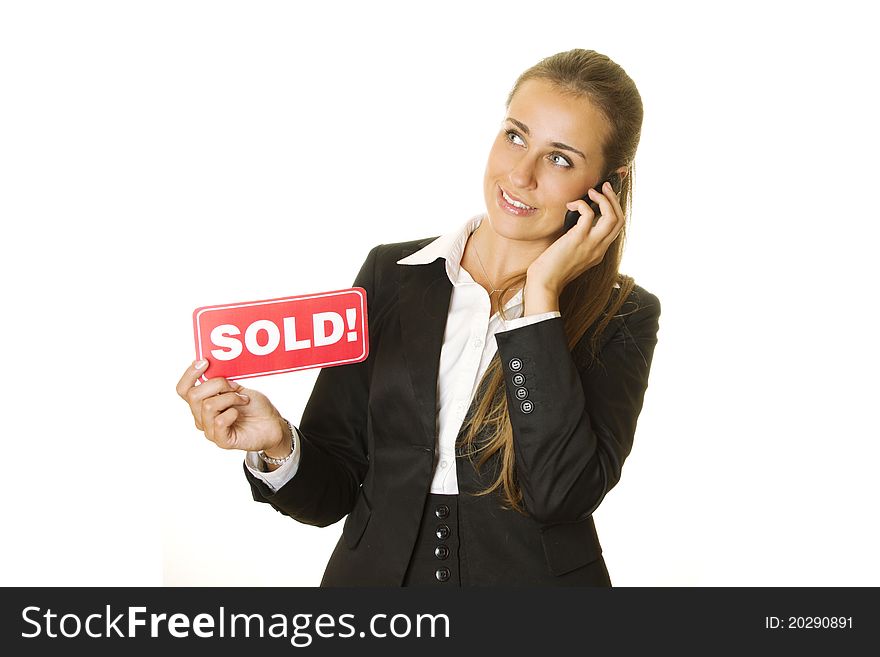 Attractive modern business woman talking on the phone and keeps the card SOLD in your other hand. isolated. Attractive modern business woman talking on the phone and keeps the card SOLD in your other hand. isolated