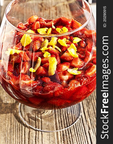 Strawberry jam with lemon zest in a transparent bowl