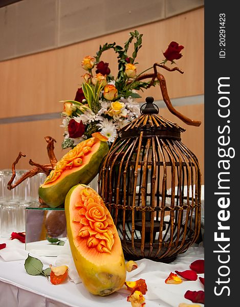 Papaya fruit crafted with pattern of roses on a buffet table. Papaya fruit crafted with pattern of roses on a buffet table
