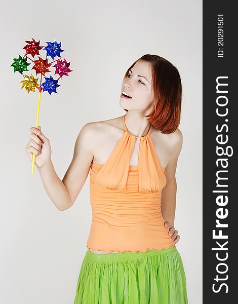 girl in bright clothes holding pinwheel