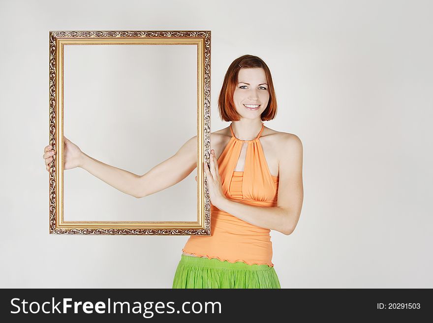 Girl in bright clothes holding decorative frame