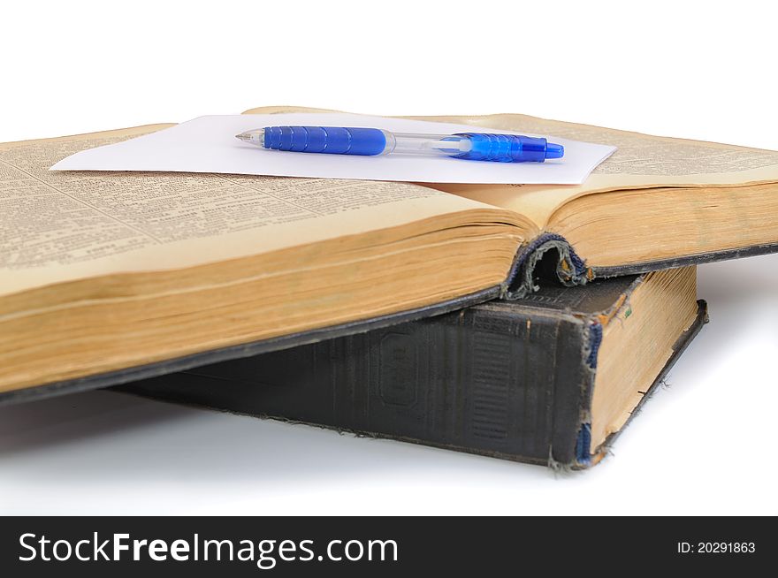 The oldest book and pen. Isolated on white background