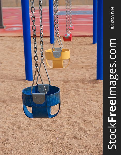 Colorful Empty Swings In Sand