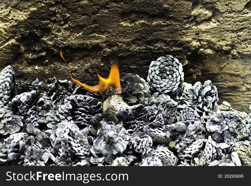 Several pine cones burning with a flame in the middle. Several pine cones burning with a flame in the middle