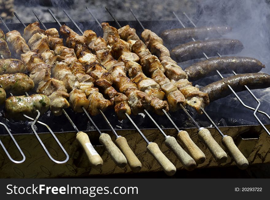 Traditional cypriot food, cooking on a charcoal grill. The food is souvlaki, seftali and pastourmas(sausage)