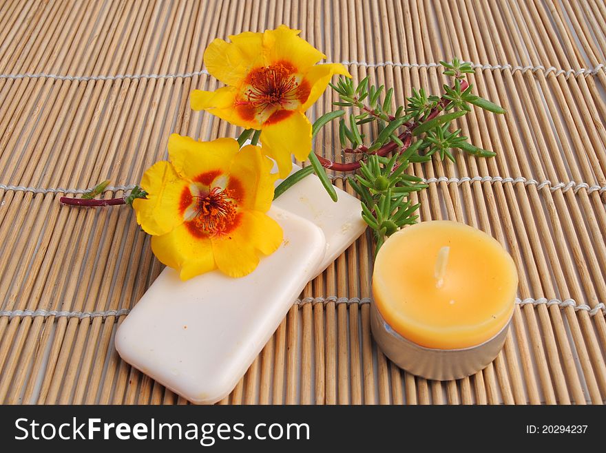 Candle and soap on bamboo background, concept of wellness