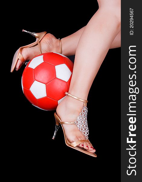 women playing elegant soccer with golden high heels and red white ball