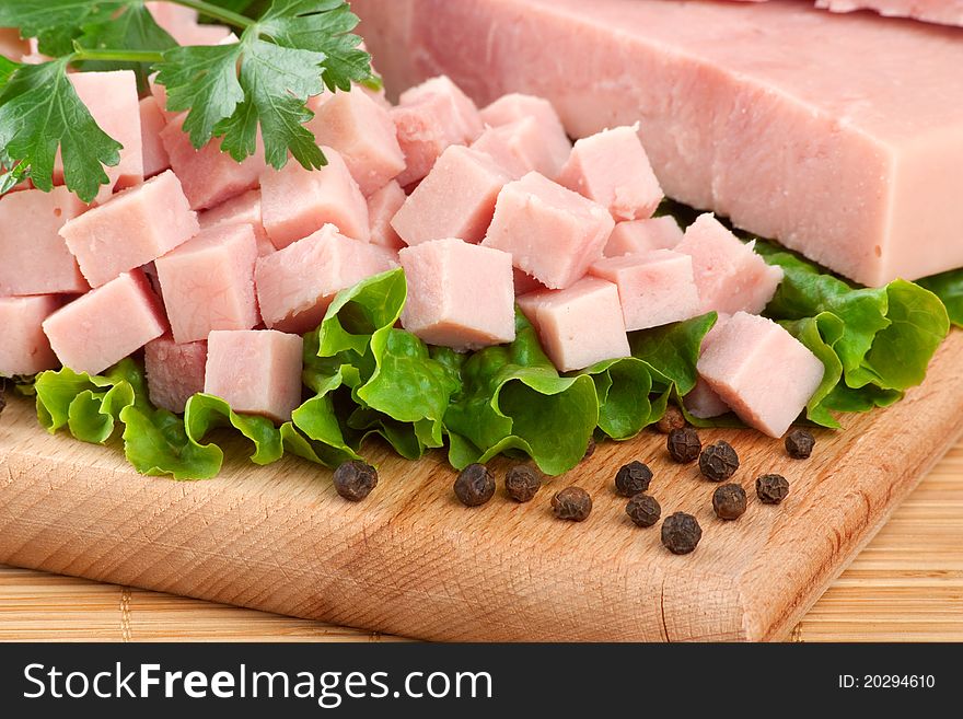 Close up photo of pork ham arranged on cutting board with parsley and lettuce. Close up photo of pork ham arranged on cutting board with parsley and lettuce