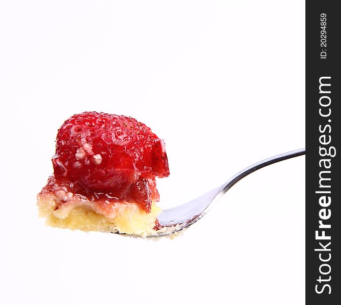 Piece of Strawberry Tart on a fork on a white background