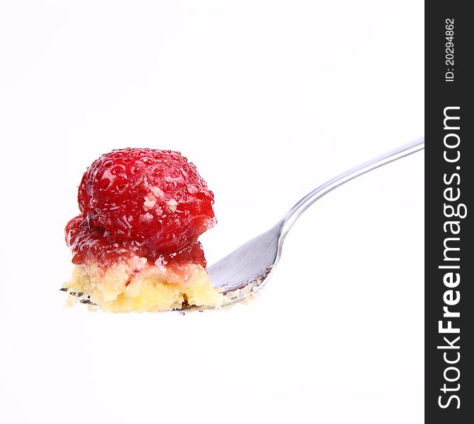 Piece of Strawberry Tart on a fork on a white background