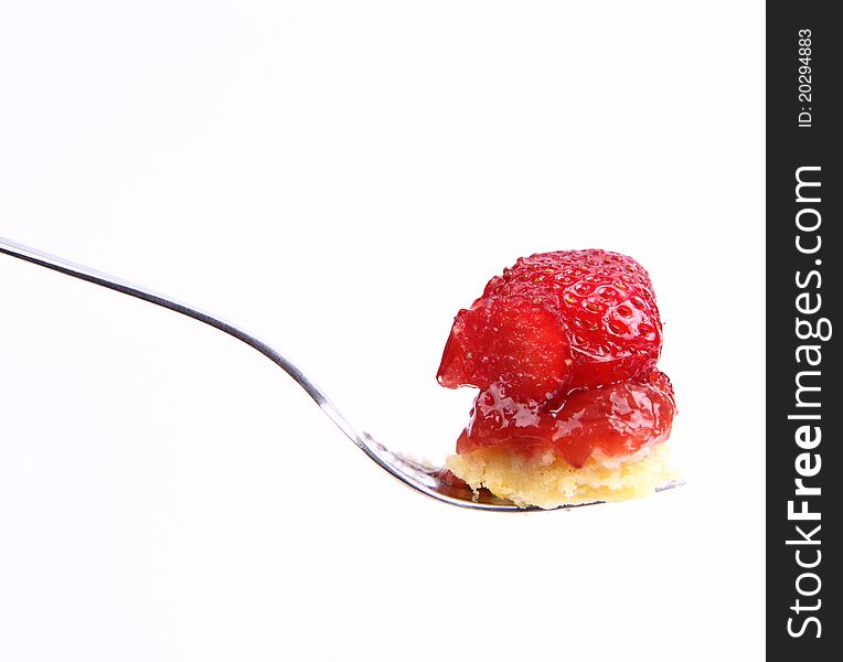 Piece of Strawberry Tart on a fork on a white background