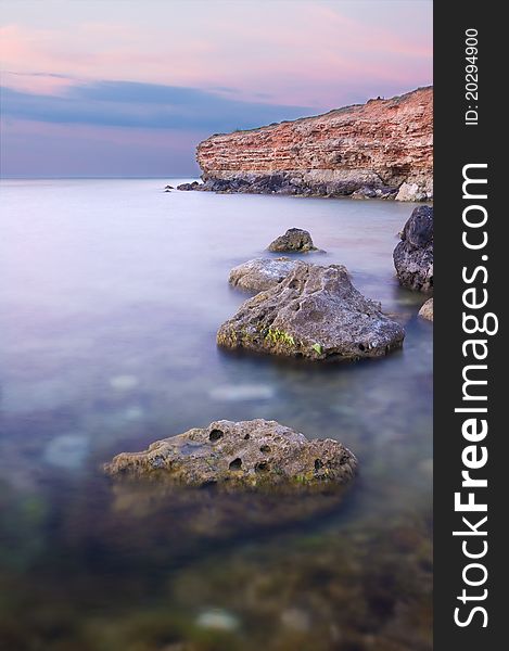 Sea and rock at the sunset. Seascape composition.