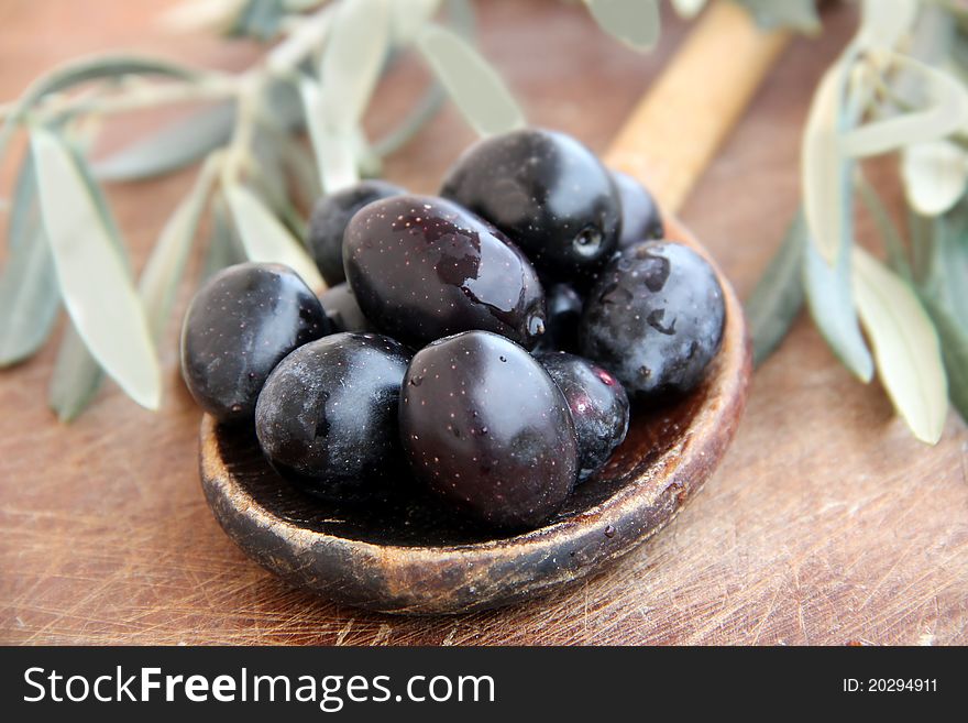 Black Olives on a wooden table