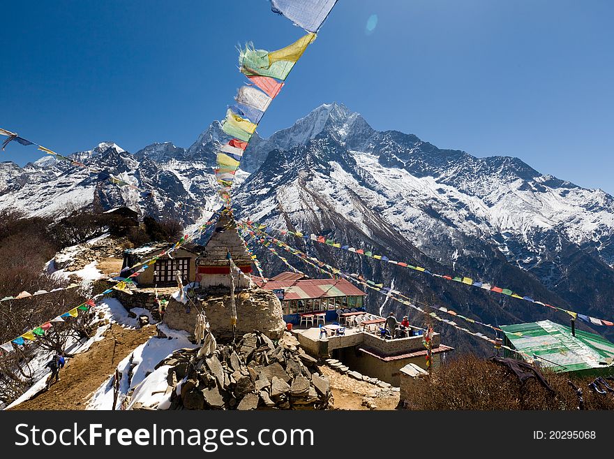 Scenic Himalayan view from Mong showing prayer flags at the crest of the pass. Scenic Himalayan view from Mong showing prayer flags at the crest of the pass