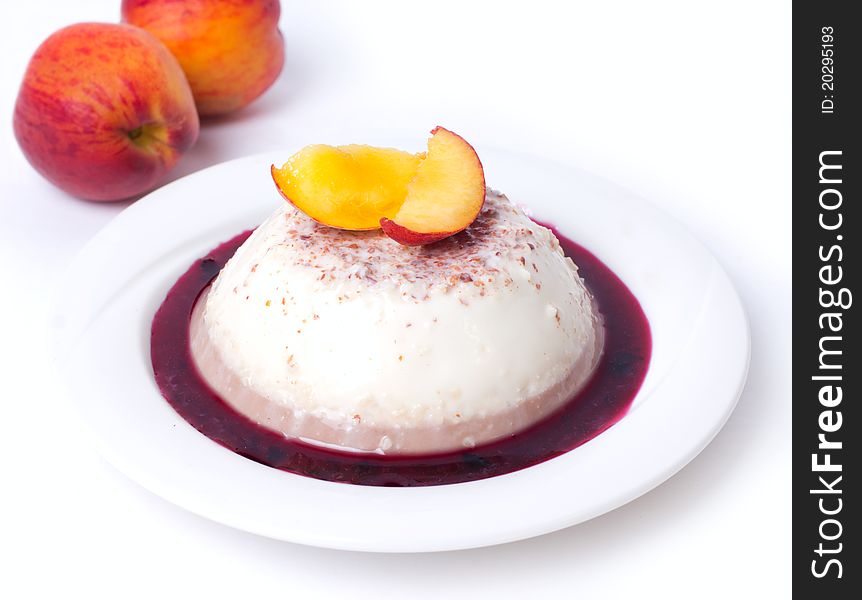 Panna-cotta with peach on white background