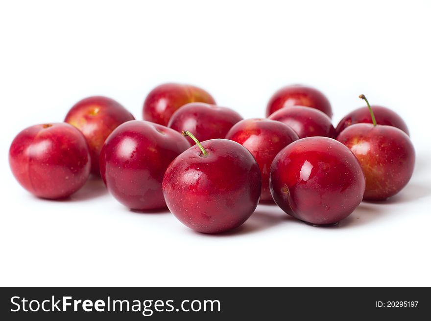 Sweet red plums isolated on white