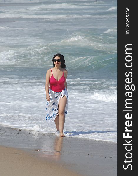 Beautiful woman walking on the beach. Beautiful woman walking on the beach