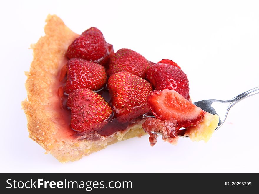 Strawberry Tart portion, a bite on a fork, on a white background