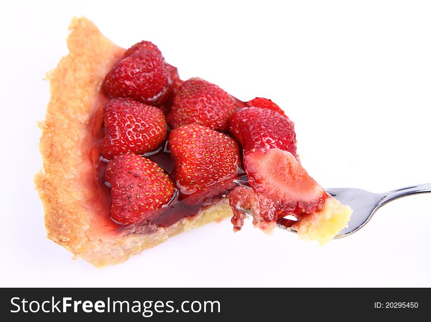 Strawberry Tart portion, a bite on a fork, on a white background