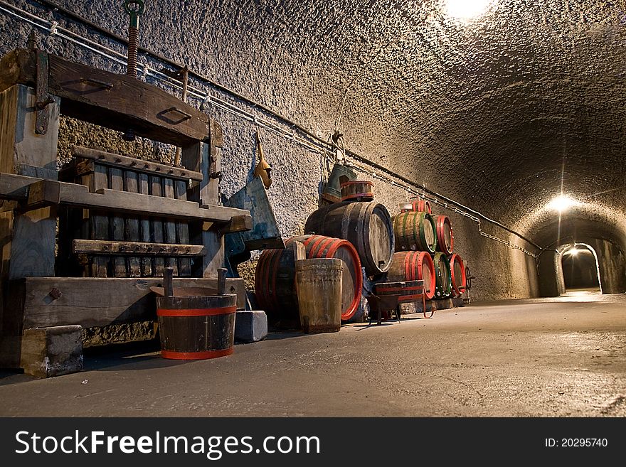 Old vine cellar with barrels and bottles