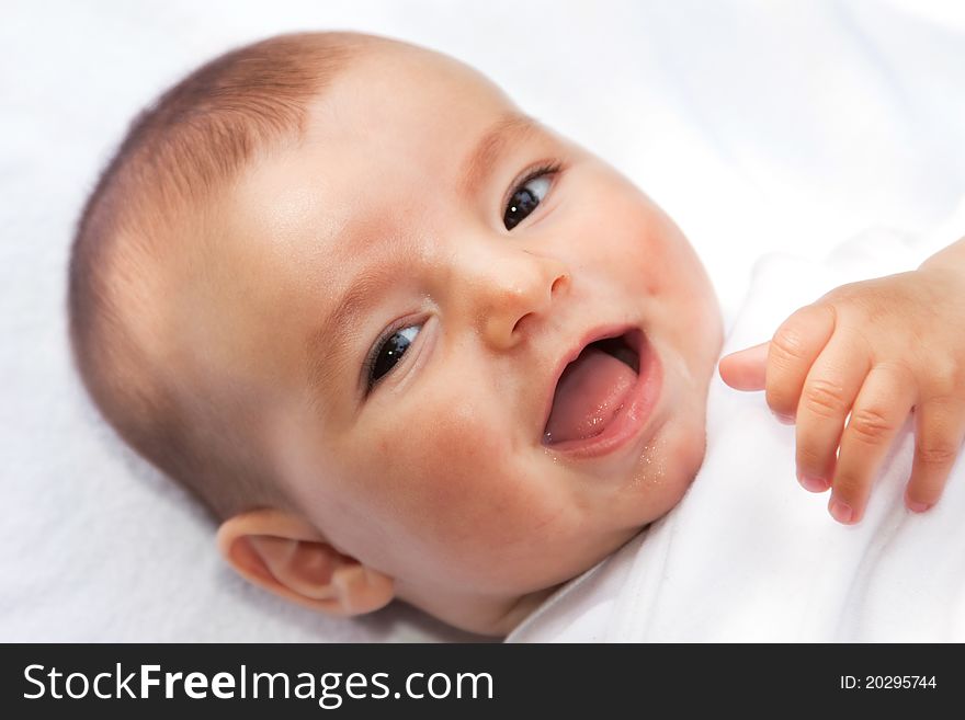 Closeup portrait of cute smiling baby boy