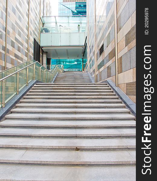 Stairs in office building with high wall