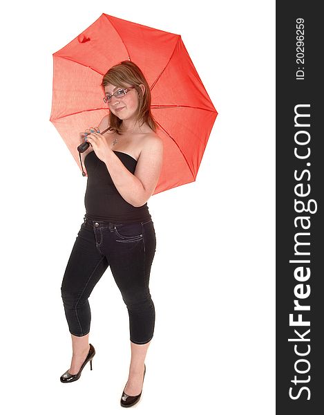 Pretty girl with a red umbrella behind her, in jeans and high heels, standing in the studio for white background. Pretty girl with a red umbrella behind her, in jeans and high heels, standing in the studio for white background.