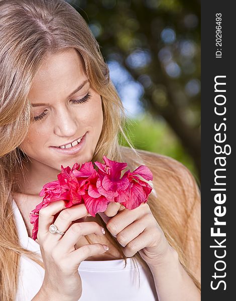 Portrait of a beauty blonde girl with flower
