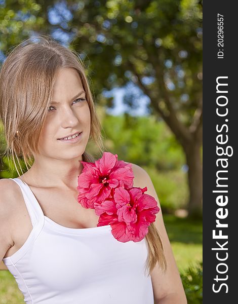 Portrait of a beauty blonde girl with red flower