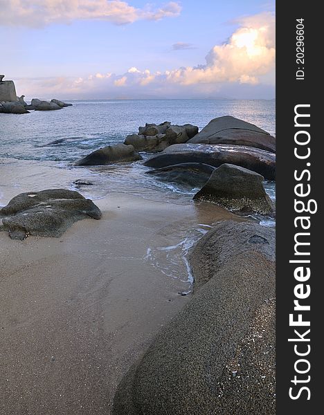 Rocky sea coast under sunset cloud, shown as featured physiognomy and landscape. Rocky sea coast under sunset cloud, shown as featured physiognomy and landscape.