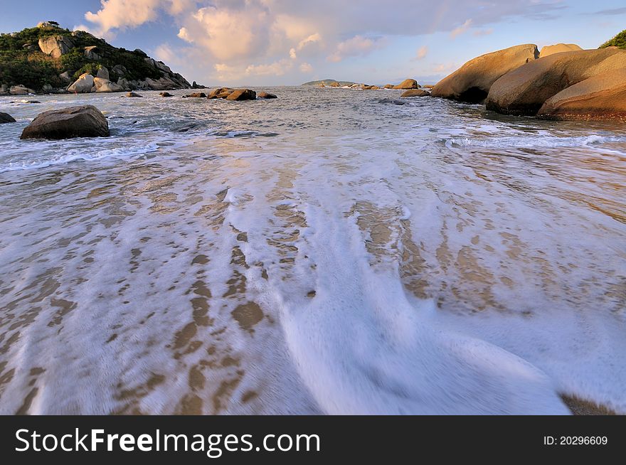 White water foam on sea beach, under sunrise lighting, shown as beach landscape and sunrise featured view. White water foam on sea beach, under sunrise lighting, shown as beach landscape and sunrise featured view.