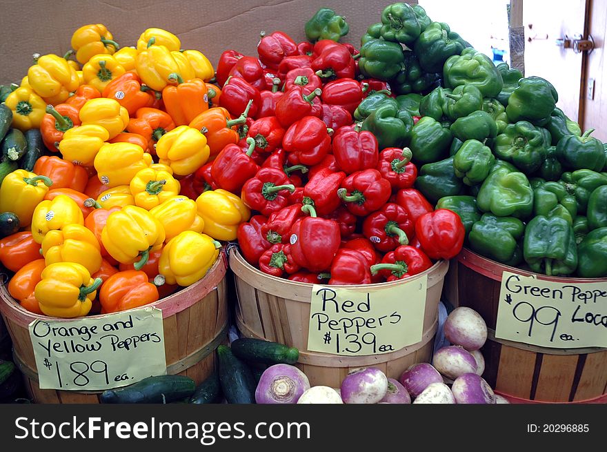 Yellow, red and green peppers in bushel baskets. Yellow, red and green peppers in bushel baskets