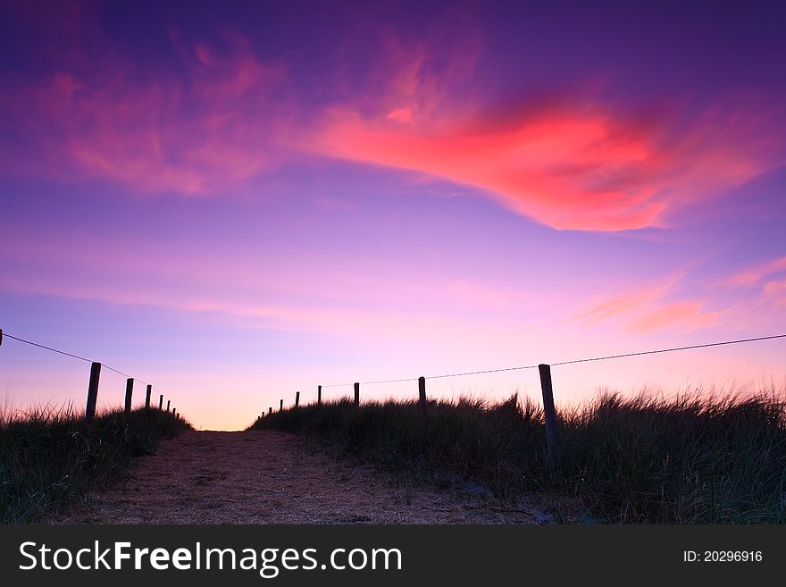 Path in the sand dunes at sunset