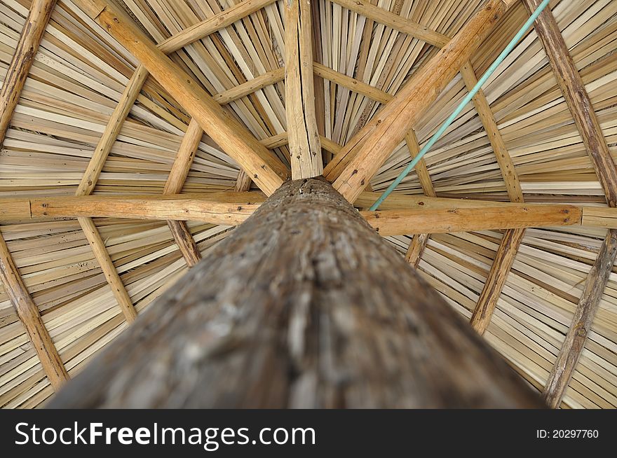 An umbrella made of palm useful to cover from the sun. An umbrella made of palm useful to cover from the sun