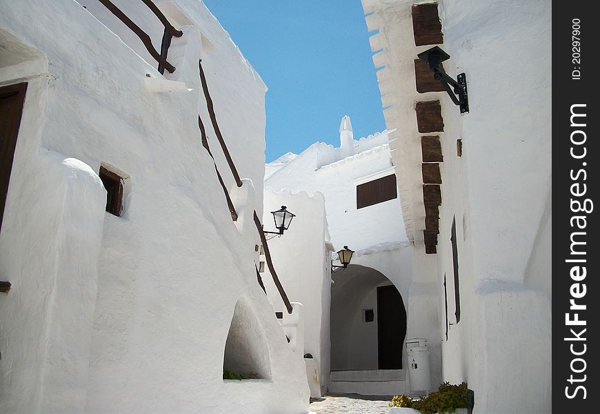 White-washed streets look like a maze in menorca. White-washed streets look like a maze in menorca.