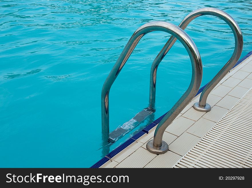 Log in outdoor pool with stairs and handrails